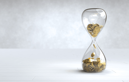 An hourglass filled with coins, dropping from the top to the bottom. This demonstrates that time is money, for financial services. 